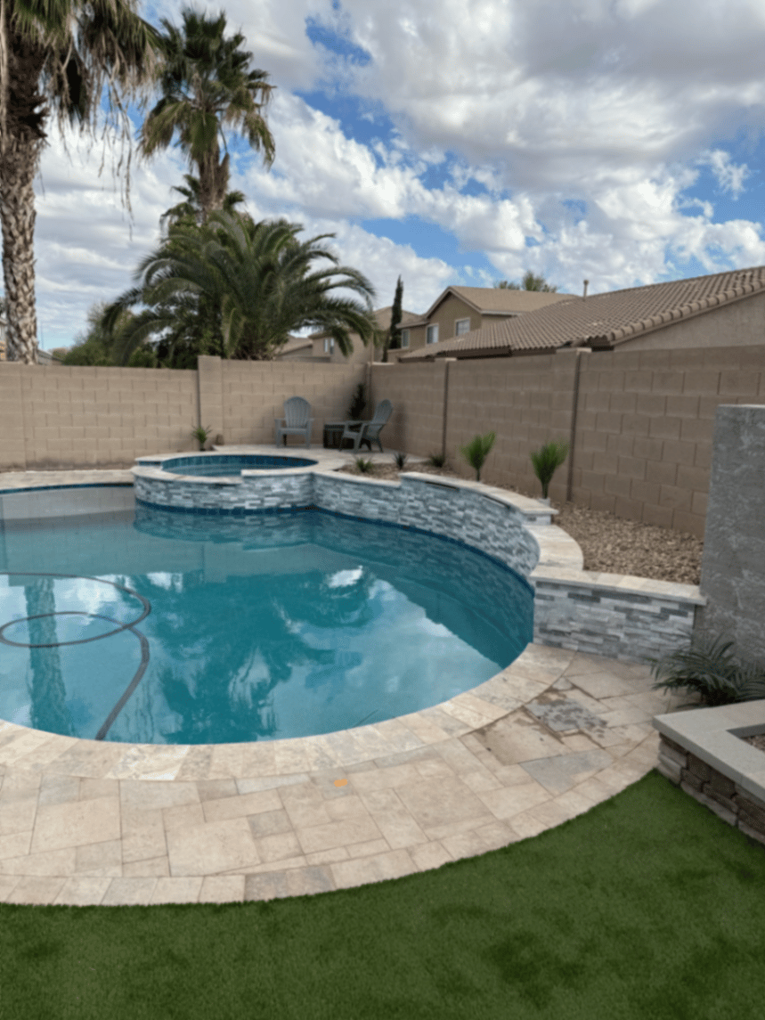 Thorn residence Mesa AZ freeform pool and raised spa framed by palms with turf corner