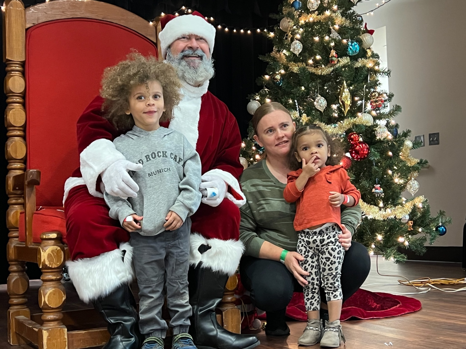 Mom and her two young children visiting Santa at Shop With a Cop
