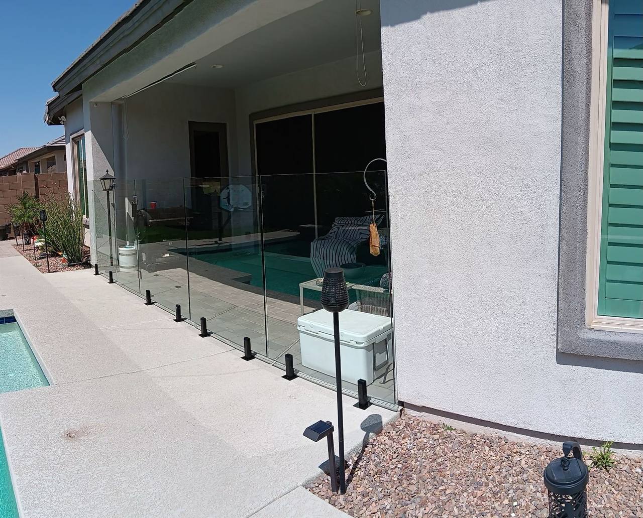 Thorn residence Mesa AZ frameless glass pool fence wrapping the pool and spa corner with surface-mount stainless spigots on cool-deck patio