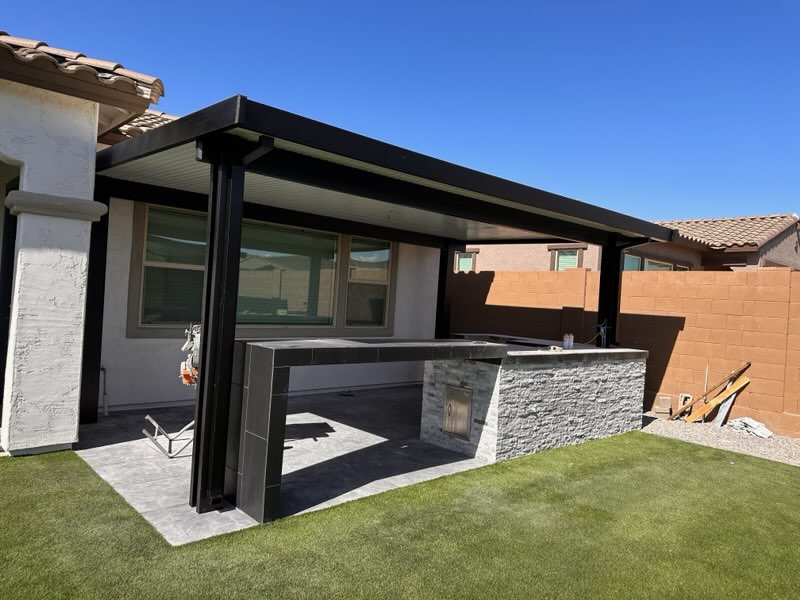 Engineered pergola shading an Arizona patio with built-in seating and lighting