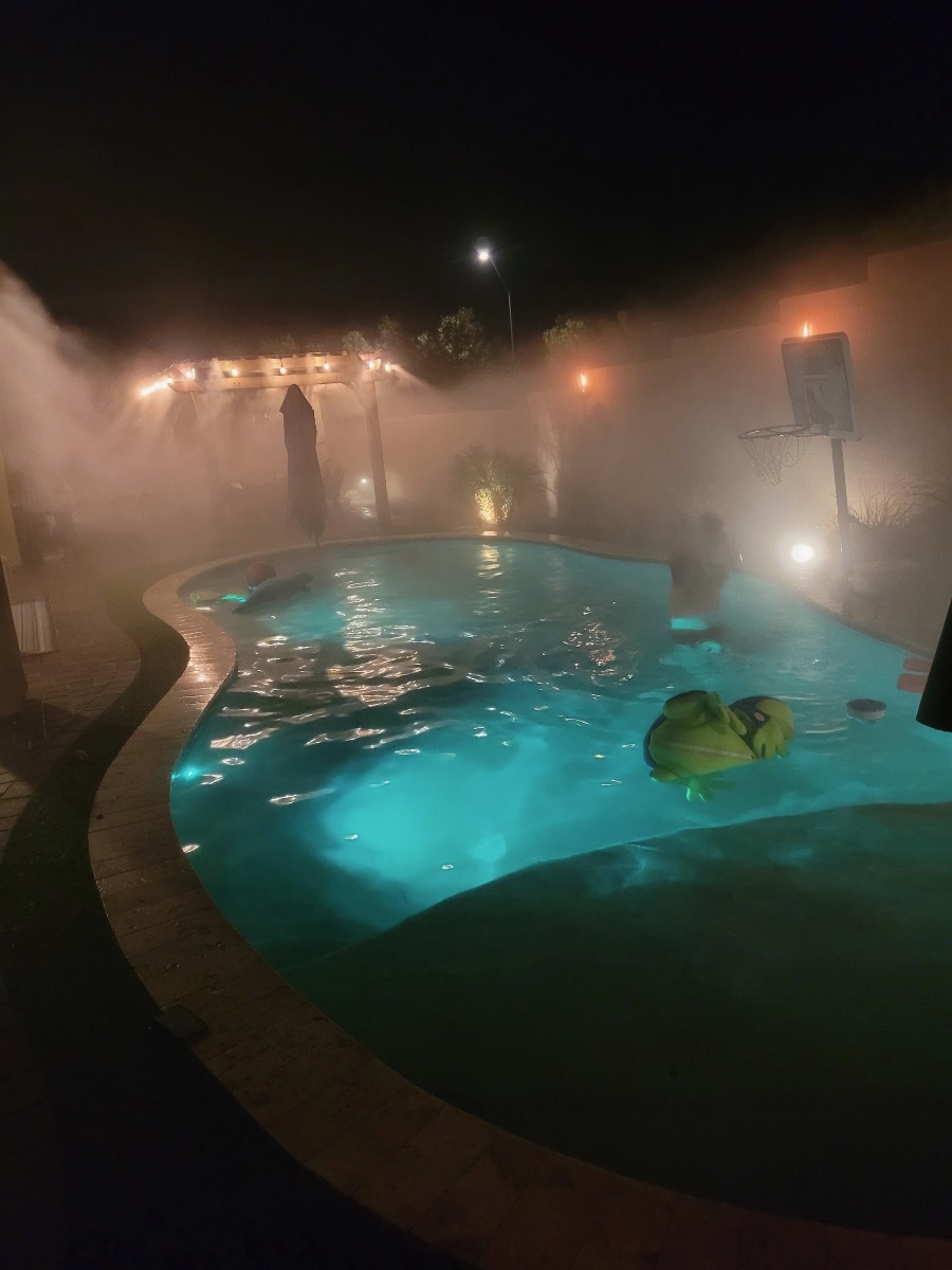Custom Arizona pool with travertine deck, raised spa, and water features by AE Outdoor Living