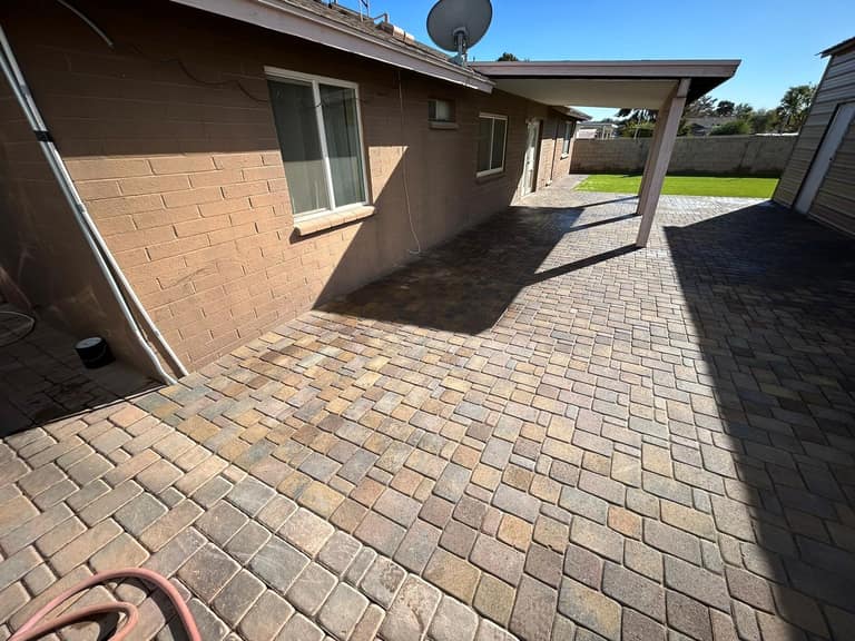 Tumbled paver wraparound running the side yard from covered porch to lawn.