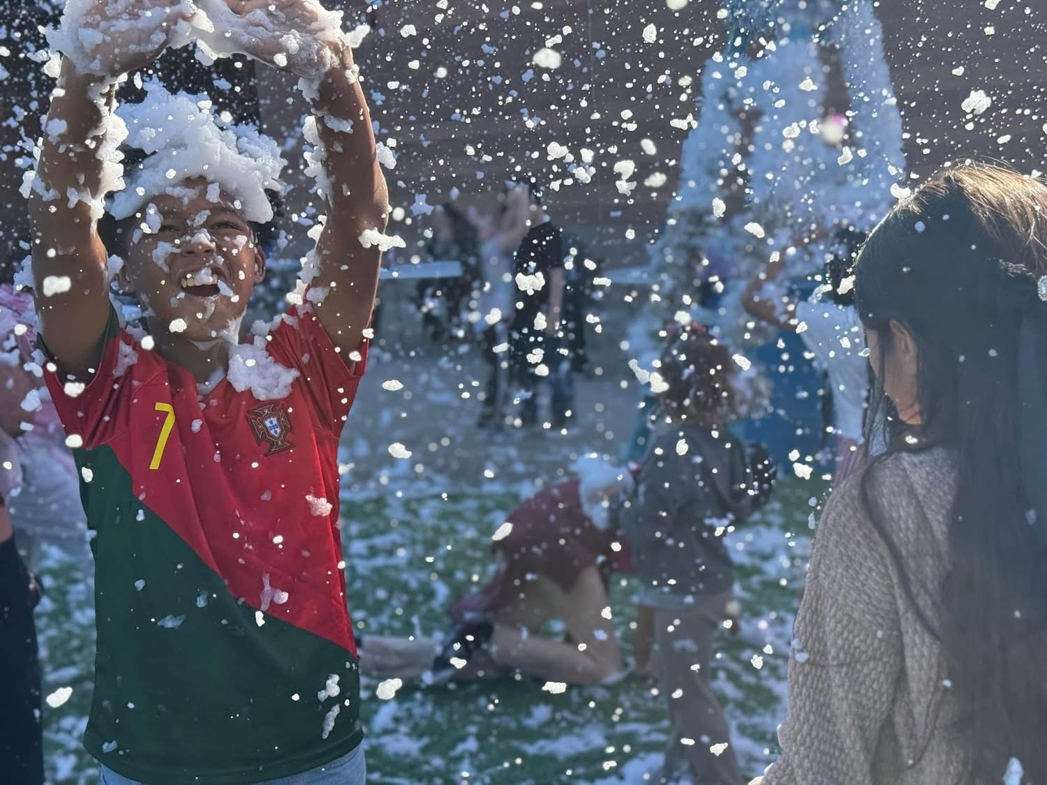 Kids playing in real snow at A Day of Giving 2025 in Peoria, Arizona
