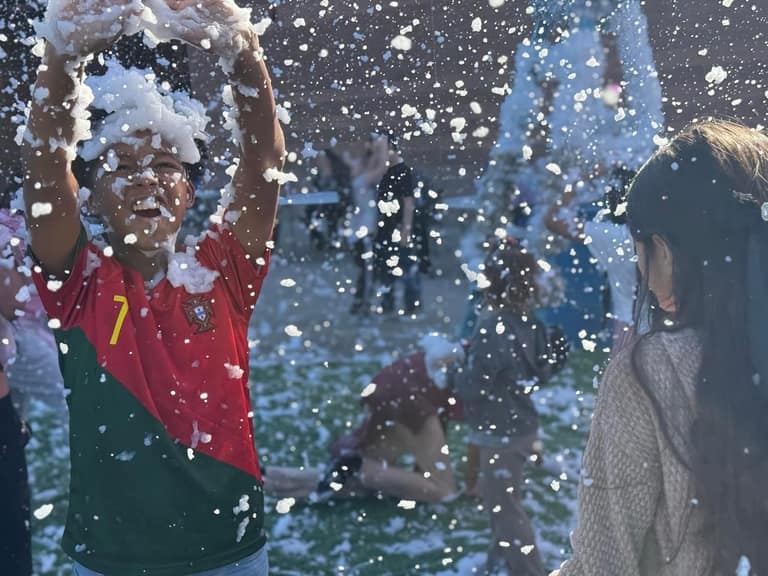 Kids playing in real snow at A Day of Giving 2025 in Peoria, Arizona