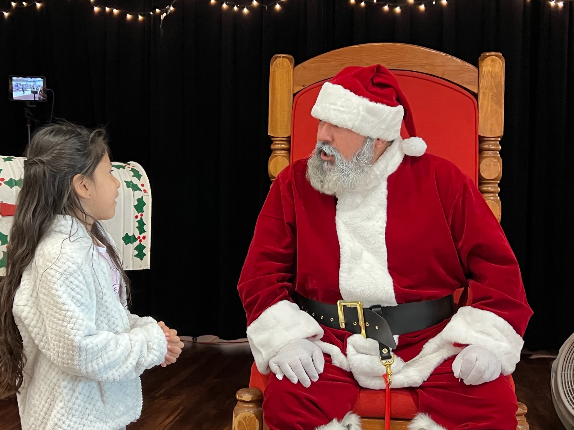 Young girl talking with Santa at Peoria Police Shop With a Cop event