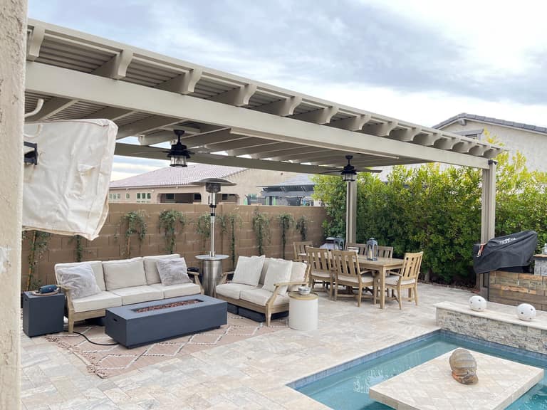 Vask residence The Meadows Peoria AZ tan alumawood lattice pergola with ceiling fans over travertine patio, sectional lounge, and teak dining set beside pool
