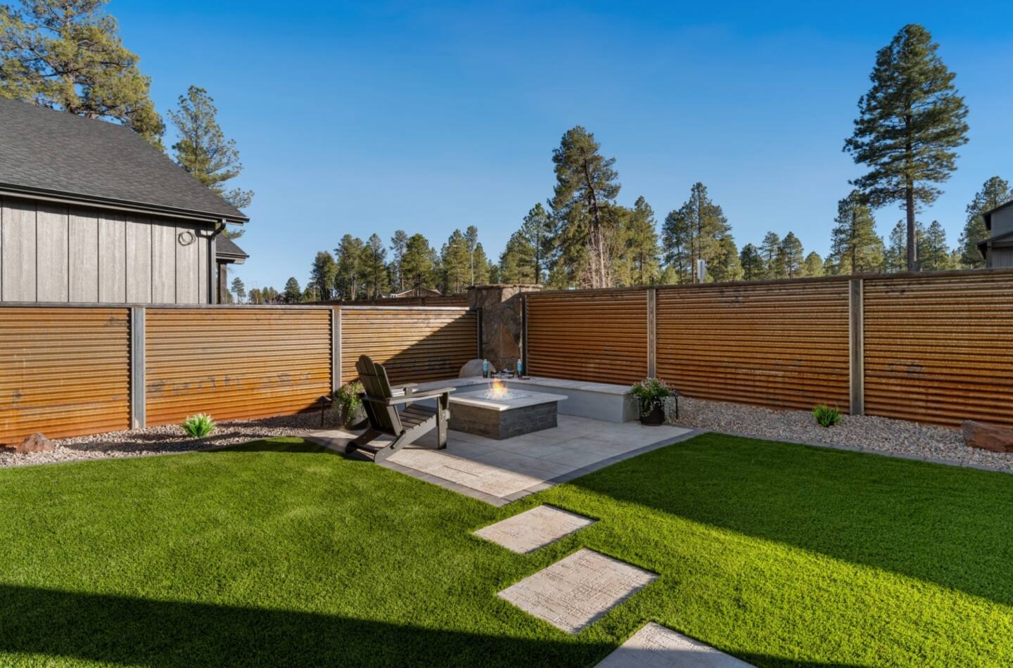 Custom fire feature with stone surround integrated into an Arizona outdoor living space