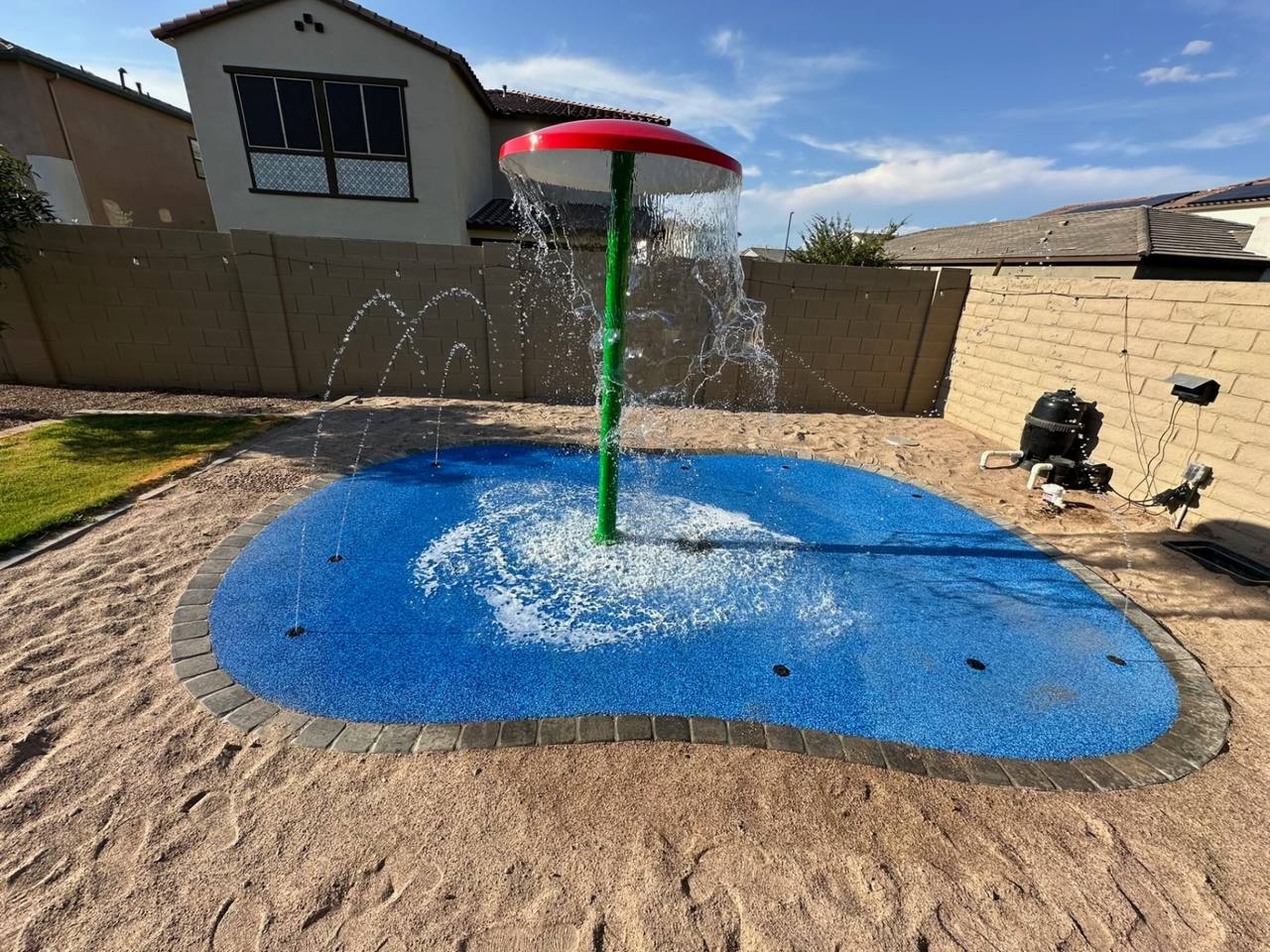 Custom Arizona pool with travertine deck, raised spa, and water features by AE Outdoor Living