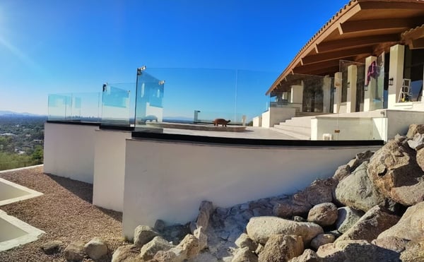 Frameless glass view railing along a hillside terrace at a Camelback Mountain–area home in Phoenix, Arizona.
