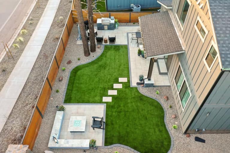 Full Arizona backyard transformation — pool, paver patio, turf, and shade structure by AE Outdoor Living