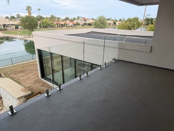 Frameless glass balcony railing with base-mounted hardware at a Scottsdale, Arizona home.