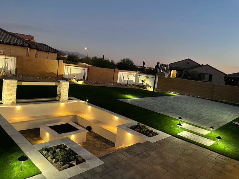 Goodyear backyard paver sport court, artificial turf lawn and sunken firepit lounge with mountain sunset view