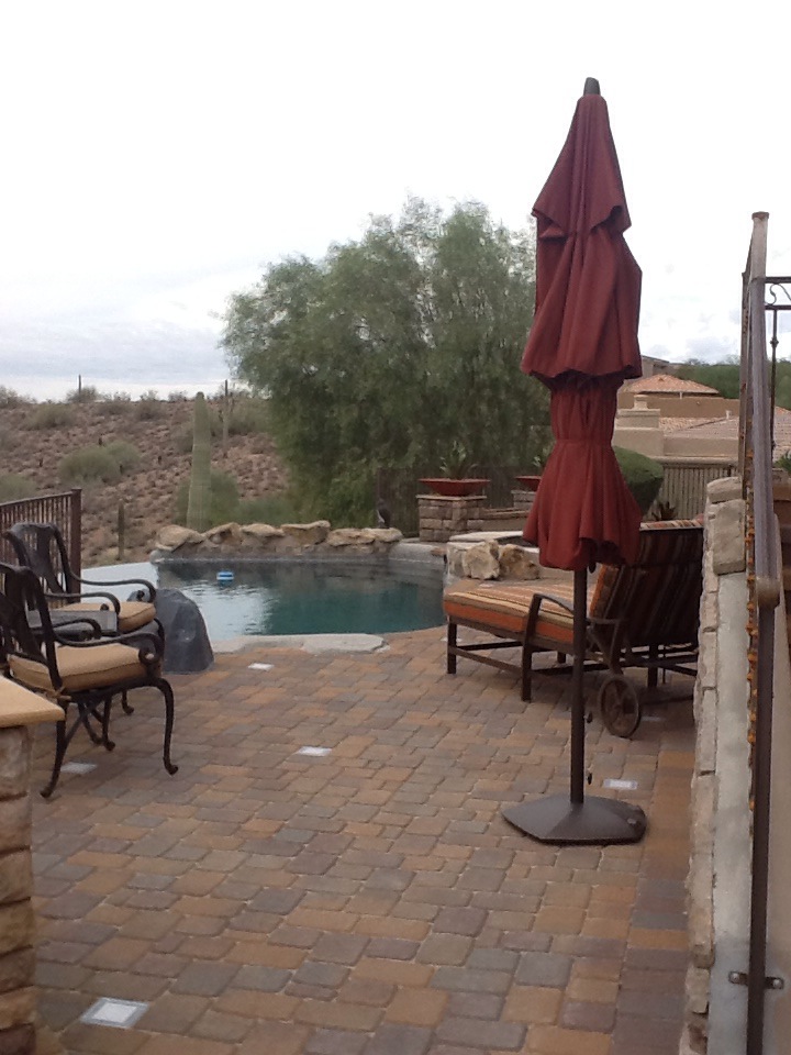 Fountain Hills freeform pool with boulder waterfall, paver pool deck and desert view by AE Outdoor Living