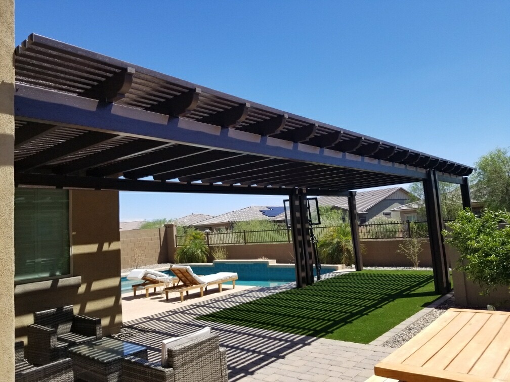 The Meadows (Peoria) backyard alumawood lattice pergola in bronze covering paver patio with pool, artificial turf lawn and wrought-iron view fencing by AE Outdoor Living
