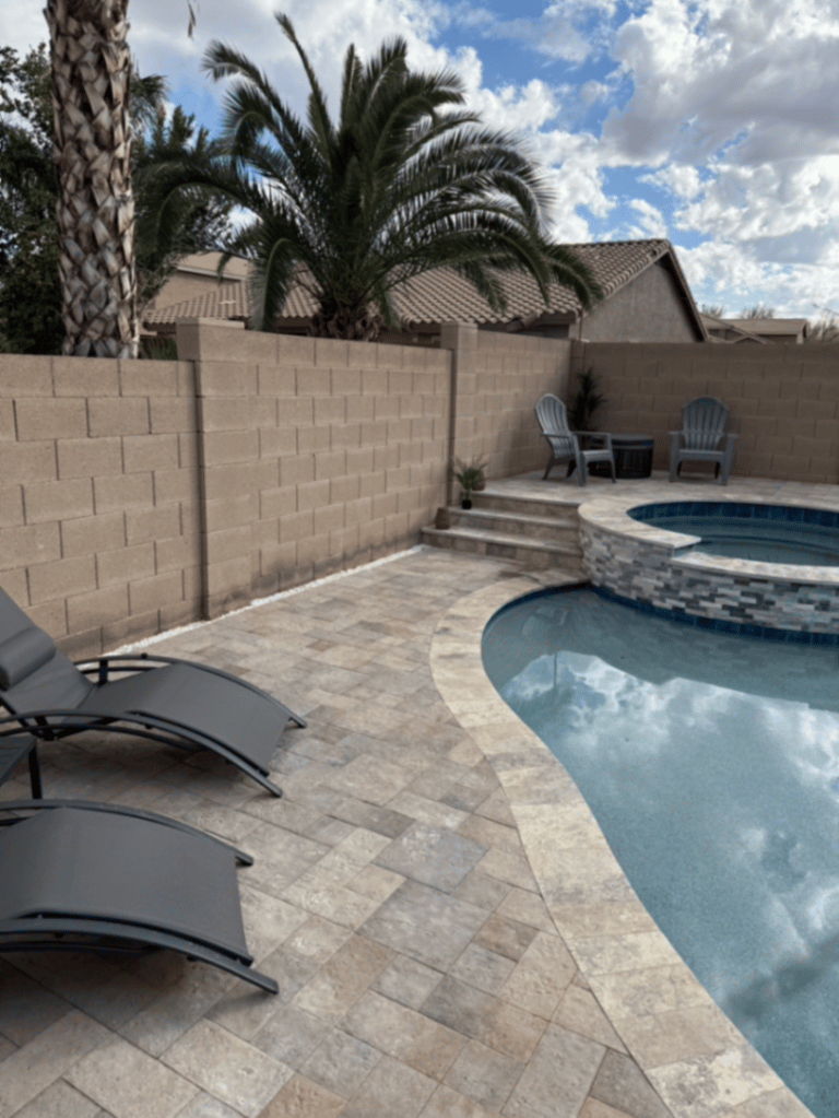 Arizona pool and spa with travertine lounge deck and mature palm backdrop