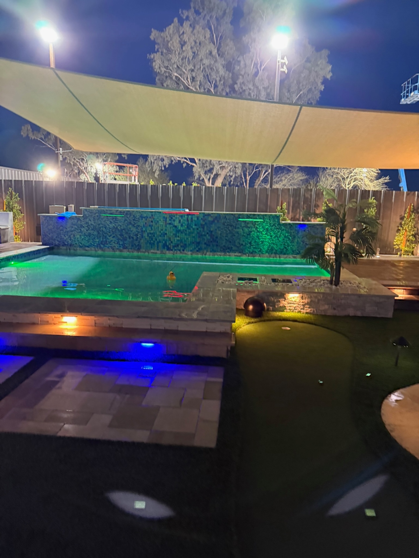Display pool with mosaic waterline tile and color-changing LED lighting