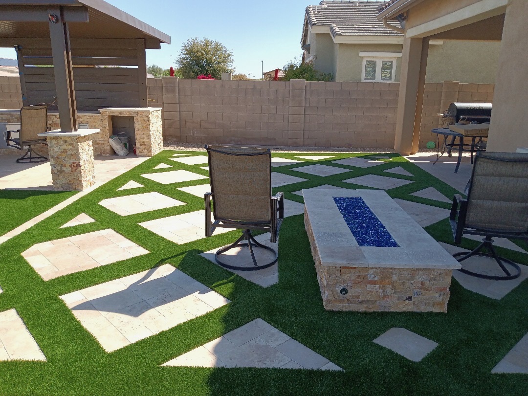 Linear fire feature set into a geometric paver-and-turf entertaining zone.