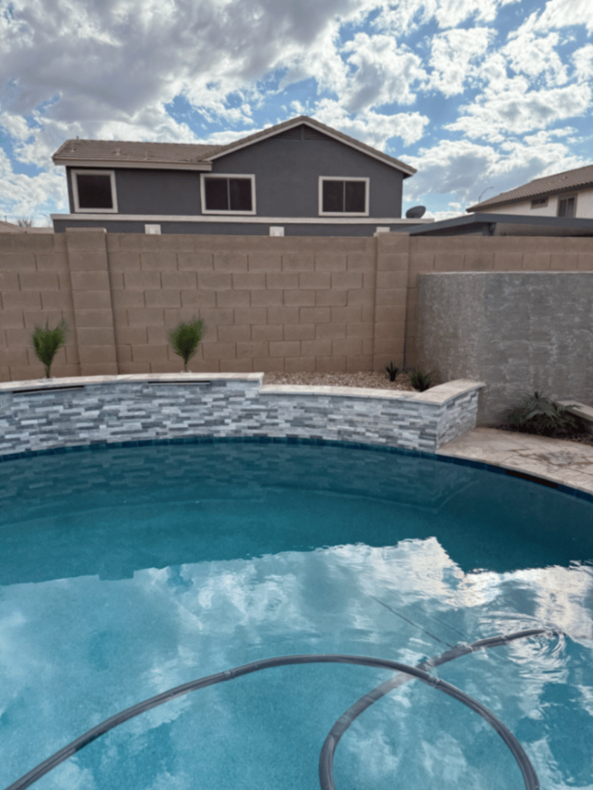Thorn residence Mesa AZ pool with stacked-stone spa wall and stucco water-feature wall