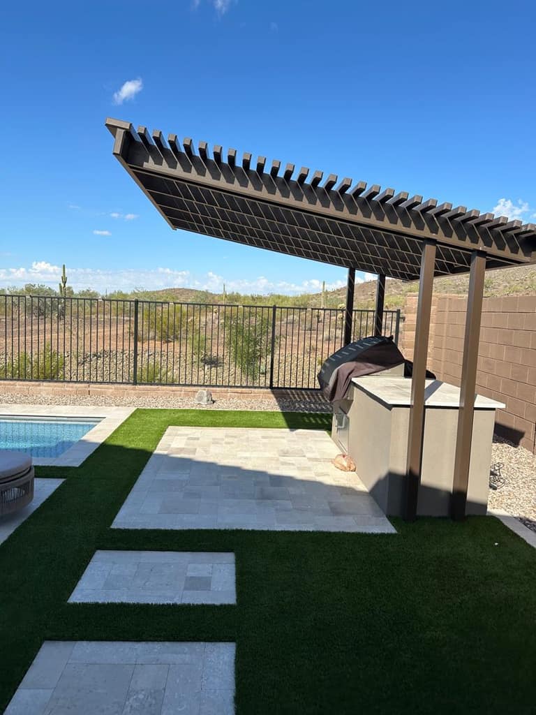 Cantilevered louvered cover sized exactly to the outdoor kitchen and grill run.