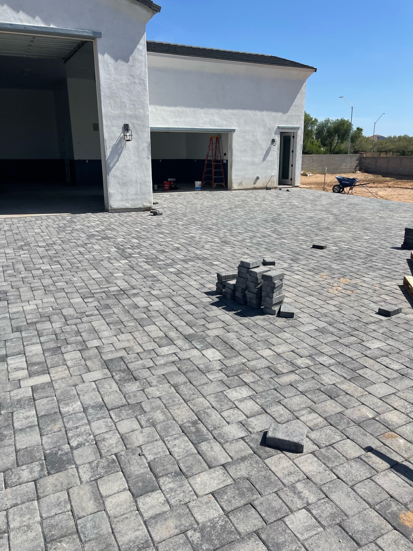 Waddell (Surprise-area) detached RV garage apron and connecting paver court installed in charcoal-blend field pavers on a 12,000 sq ft project by AE Outdoor Living