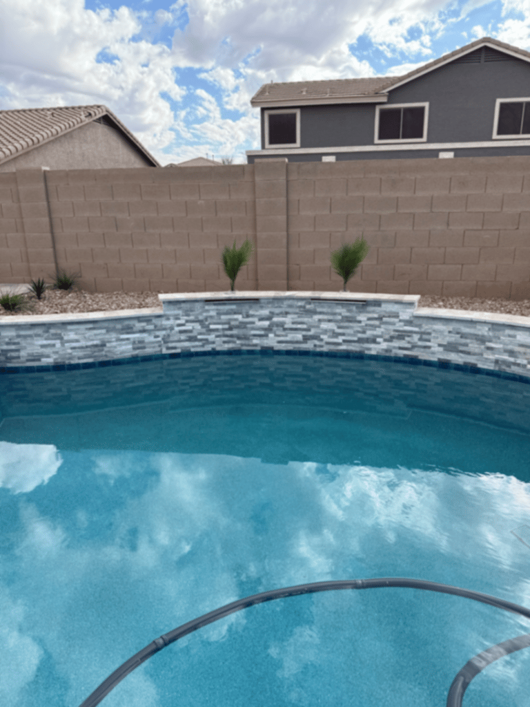 Thorn residence Mesa AZ close-up of stacked-stone spa wall and waterline tile band