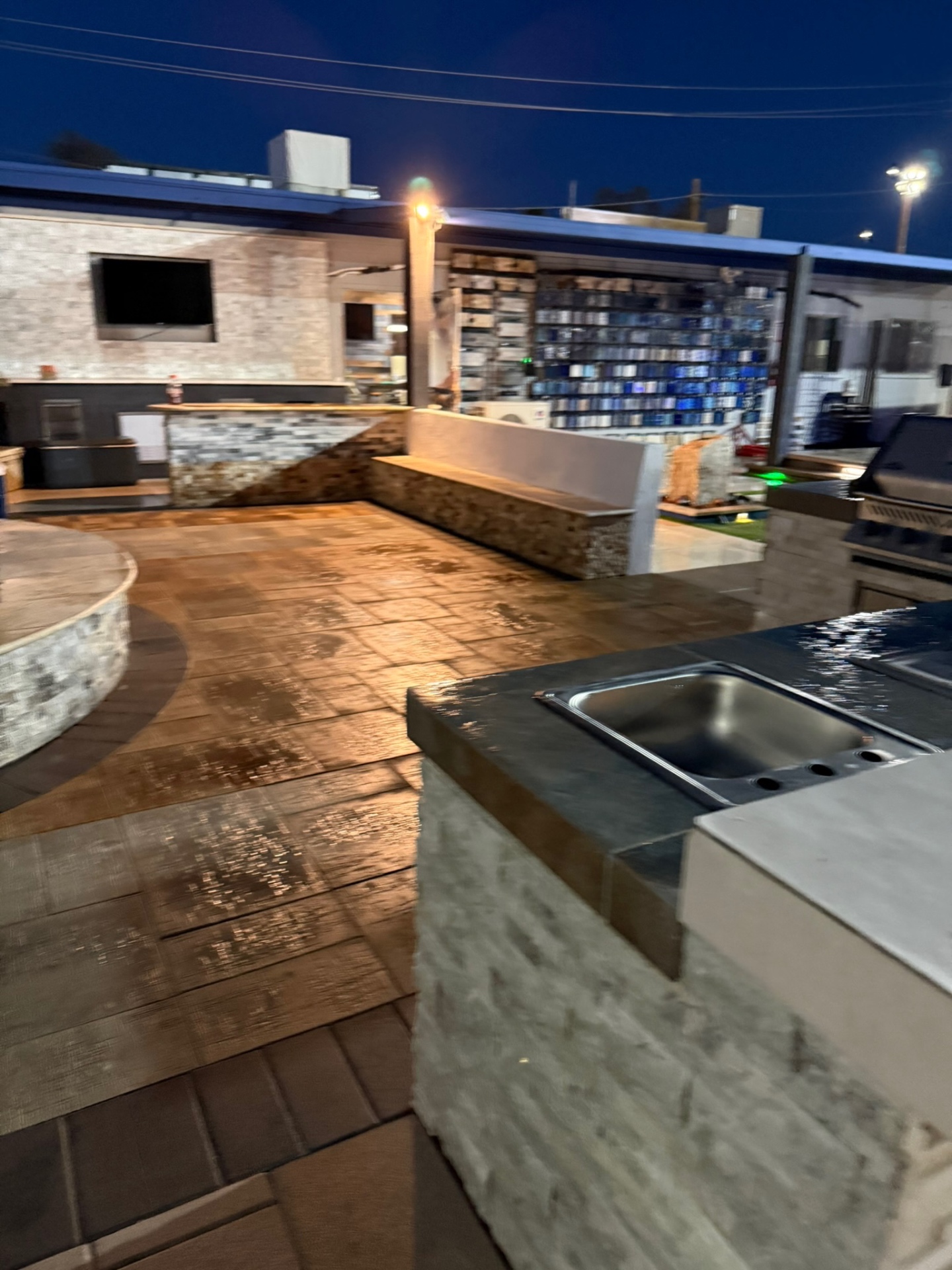 Outdoor lounge with TV and full tile sample wall
