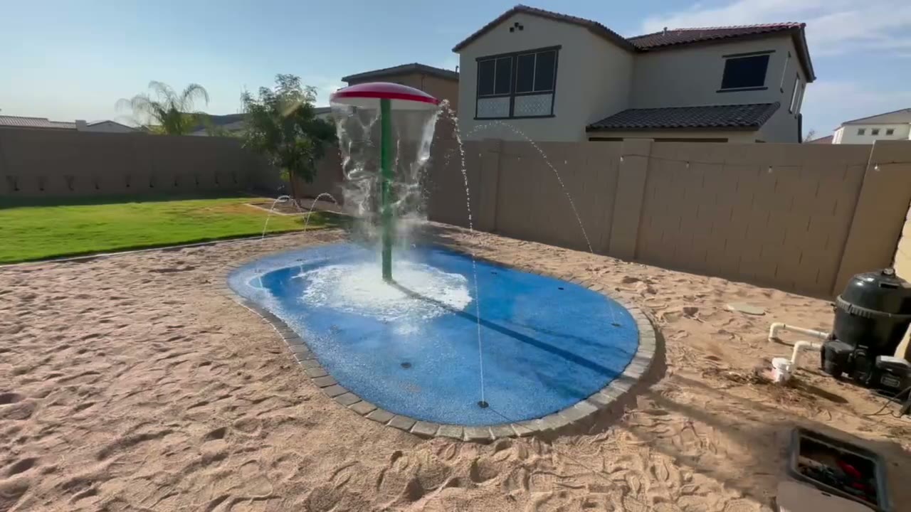 Water play features on an AE Outdoor Living splash pad deck in Arizona.