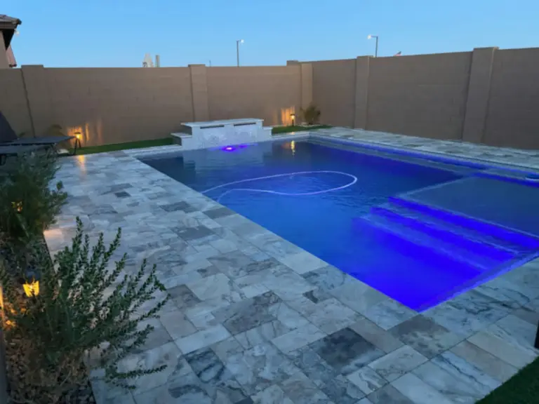 Twilight pool finish, lighting, and clean coping lines.