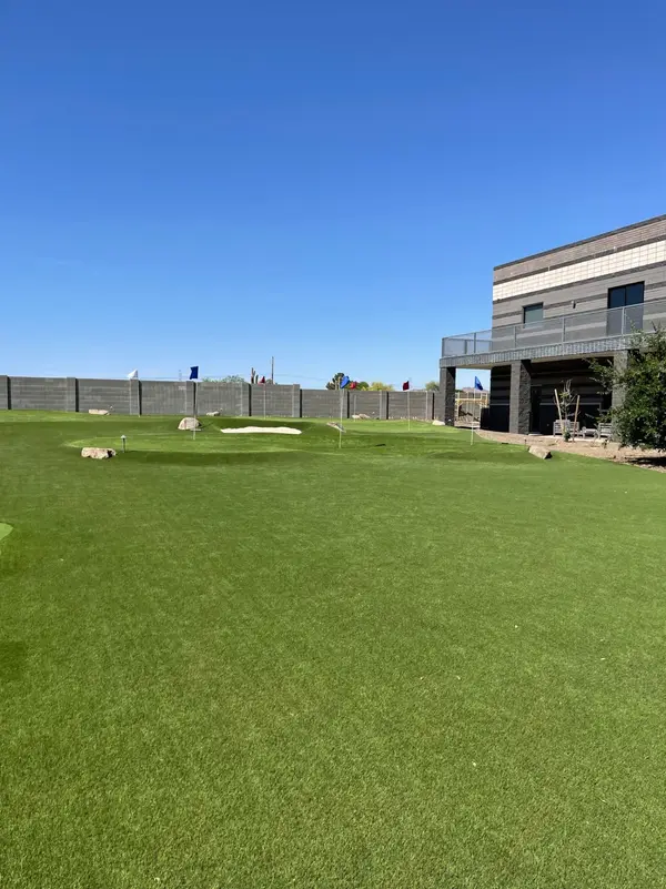 Putting green installation with fringe turf and cup placement
